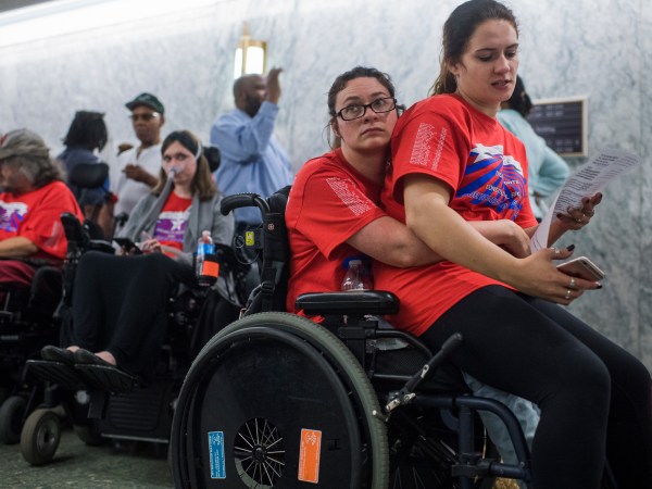 UNITED STATES - SEPTEMBER 25: Shaylin Sluzalis, right, and her sister Brittani, who has cerebral palsy, wait in line for a Senate Finance Committee hearing in Dirksen on the proposal by Sens. Lindsey Graham,R-S.C., and Bill Cassidy, R-La., to repeal and replace the Affordable Care Act, which they oppose, on September 25, 2017. Both senators are scheduled to testify. (Photo By Tom Williams/CQ Roll Call)