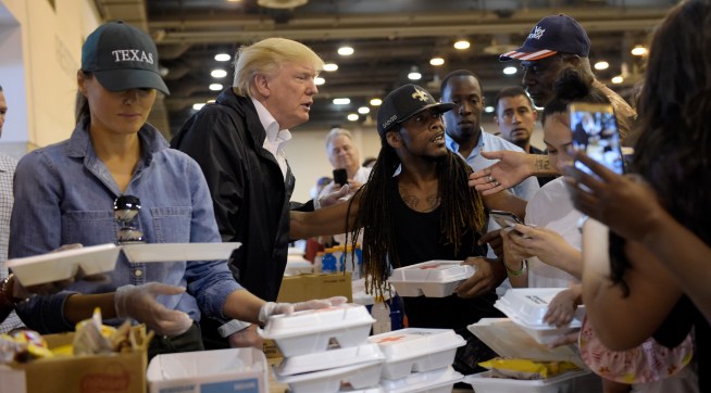 President Donald Trump and Melania Trump pass out food and meet people impacted by Hurricane Harvey during a visit to the NRG Center in Houston, Saturday, Sept. 2, 2017. The Trumps will also make a stop in Lake Charles, La., to meet with people at an emergency operations center. (AP Photo/Susan Walsh)