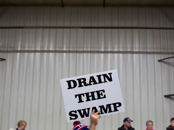 FILE - In this Oct. 27, 2016, file photo, supporters of then-Republican presidential candidate Donald Trump hold signs during a campaign rally in Springfield, Ohio. President-elect Donald Trump’s campaign promise to “drain the swamp” of Washington might make it difficult for him to fill all the jobs in his administration. (AP Photo/ Evan Vucci, file)