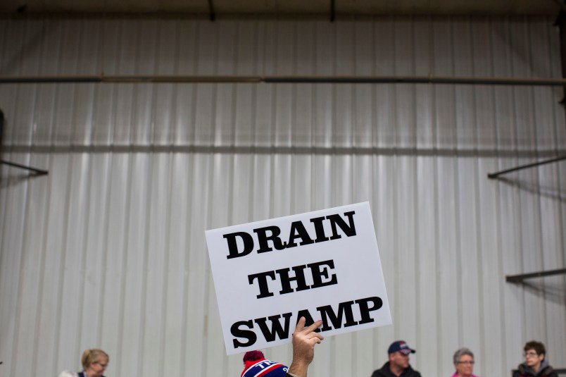 FILE - In this Oct. 27, 2016, file photo, supporters of then-Republican presidential candidate Donald Trump hold signs during a campaign rally in Springfield, Ohio. President-elect Donald Trump’s campaign promise to “drain the swamp” of Washington might make it difficult for him to fill all the jobs in his administration. (AP Photo/ Evan Vucci, file)