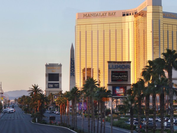 A roadblock is shown on the Las Vegas Strip through a glass partition near Mandalay Bay hotel-casino shortly after sunrise Monday, Oct. 2, 2017, in Las Vegas. A mass shooting occurred late night Sunday at a music festival on the Las Vegas Strip. (AP Photo/Ronda Churchill)