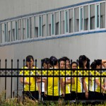In this Sept. 5, 2017, photo, North Korean workers gather after lunch at the Hong Chao Zhi Yi garment factory in Hunchun in northeastern China's Jilin province. At a time when North Korea faces sanctions on many exports, the outsourcing of tens of thousands of workers worldwide brings in revenue estimated at anywhere from $200 million to $500 million. That could account for a sizable portion of its nuclear weapons and missile programs, which South Korea says has cost well over $1 billion. (AP Photo/Ng Han Guan)