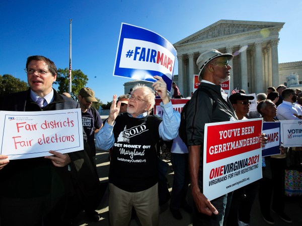 Eric Silberman from Silver Spring, Md., from left,Charlie Cooper from Baltimore, Md., and Clay Wilson from Alexandria, Va., join others in a rally for a fair election outside the U.S. Supreme Court in Washington, Tuesday, Oct. 3, 2017. The Supreme Court hears arguments in a case about political maps in Wisconsin that could affect elections across the country. (AP Photo/Manuel Balce Ceneta)