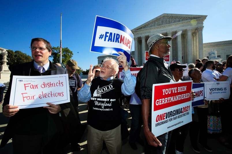 Eric Silberman from Silver Spring, Md., from left,Charlie Cooper from Baltimore, Md., and Clay Wilson from Alexandria, Va., join others in a rally for a fair election outside the U.S. Supreme Court in Washington, Tuesday, Oct. 3, 2017. The Supreme Court hears arguments in a case about political maps in Wisconsin that could affect elections across the country. (AP Photo/Manuel Balce Ceneta)