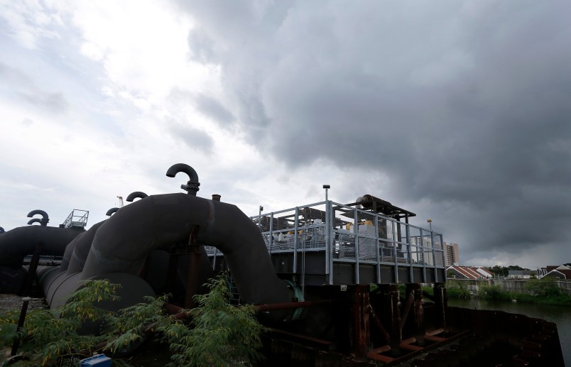 FILE -In this Thursday, Aug. 10, 2017 file photo, rain clouds gather over the 17th Street Canal pumping station in New Orleans.  Flood-weary New Orleans braced Thursday for the weekend arrival of Tropical Storm Nate, forecast to hit the area Sunday morning as a weak hurricane that could further test a city drainage system in which weaknesses were exposed during summer deluges.(AP Photo/Gerald Herbert, File)