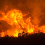 Flames from a massive wildfire burn  Monday, Oct. 9, 2017, in Napa, Calif.  (AP Photo/Rich Pedroncelli)