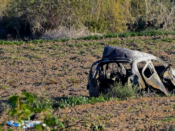 The wreckage of the car of investigative journalist Daphne Caruana Galizia lies next to a road in the town of Mosta, Malta, Monday, Oct. 16, 2017. Malta's prime minister says a car bomb has killed an investigative journalist on the island nation. Prime Minister Joseph Muscat said the bomb that killed reporter Daphne Caruana Galizia exploded Monday afternoon as she left her home in a town outside Malta's capital, Valetta. (AP Photo/Rene Rossignaud)