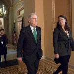 Senate Majority Leader Mitch McConnell, R-Ky., joined at right by Secretary for the Majority Laura Dove, walks from his office to the chamber for the start of the legislative day, at the Capitol in Washington, Tuesday, Oct. 17, 2017. Monday, President Donald Trump and Mitch McConnell reaffirmed their alliance of necessity in a raucous Rose Garden news conference that also underscored their sharp differences. (AP Photo/J. Scott Applewhite)