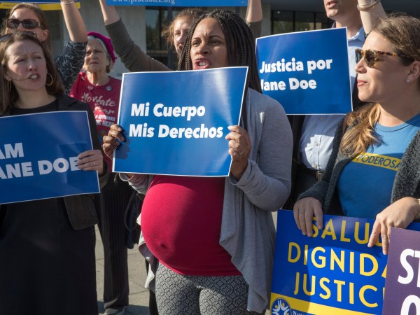 Activists with Planned Parenthood demonstrate in support of "Jane Doe," a pregnant 17-year-old being held in a Texas facility for unaccompanied immigrant children to obtain an abortion, outside of the Department of Health and Human Services in Washington, Friday, Oct. 20, 2017. (AP Photo/J. Scott Applewhite)