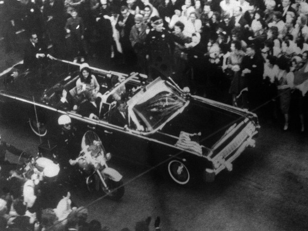 This overhead view of President Kennedy's car in Dallas motorcade on Nov. 22, 1963, was Warren Commission Exhibit No. 698. Special agent Clinton J. Hill is shown riding atop the rear of the limousine. The Warren Commission said agent Hil had to leave the left front running board of the President's follow-up car four times because of dense crowds to ride on the rear of the presidential limousine. (AP Photo)