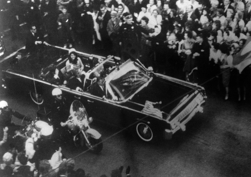This overhead view of President Kennedy's car in Dallas motorcade on Nov. 22, 1963, was Warren Commission Exhibit No. 698. Special agent Clinton J. Hill is shown riding atop the rear of the limousine. The Warren Commission said agent Hil had to leave the left front running board of the President's follow-up car four times because of dense crowds to ride on the rear of the presidential limousine. (AP Photo)
