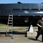 FILE - The Danish navy says it is searching for a nearly 18-meter-long (59.4-feet), 40-ton privately built submarine in the waters off Copenhagen with at least two people onboard. The submarine and the owner Peter Madsen is seen in this April 30 2008 file photo. (Niels Hougaard/AP via Ritzau FILE)  DENMARK OUT