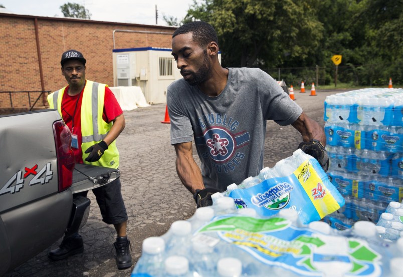 Shawn Jones, 42, right, and Tony Price, 54, distribute bottled water at a point of distribution (POD) at Saint Mark Missionary Baptist Church on Friday, August 11, 2017, in Flint's Second Ward. The POD closes today. Jones, who's been driving pallets of water to the site since November, said he hasn't seen demand slacken. He worries that as PODs close in Flint over the next month, city residents will crowd those that remain open. "I don't see this ending," he said. "It's going to be hectic." Asserting that Flint's water is now generally safe to drink, state and city officials have begun to reduce the number of bottled water points of distribution, or PODs, in the city. The closures begin today with two sites, one in the Second Ward and another in the Third. On September 5, three more will close, in the Fifth, Seventh and Eighth wards respectively. A total of four PODs, located in the First, Fourth, Sixth and Ninth wards, are slated to remain open indefinitely. Terray Sylvester | MLive.com