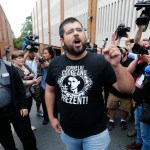 An alt-right supporter, Matthew Heinbach, right, voices his displeasure at the media after a court hearing for James Alex Fields Jr., in front of court in Charlottesville, Va., Monday, Aug. 14, 2017.  (AP Photo/Steve Helber)