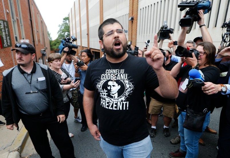 An alt-right supporter, Matthew Heinbach, right, voices his displeasure at the media after a court hearing for James Alex Fields Jr., in front of court in Charlottesville, Va., Monday, Aug. 14, 2017.  (AP Photo/Steve Helber)