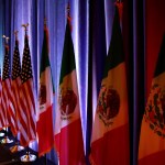 The flags of Canada, the U.S. and Mexico are lit by stage lights before a news conference, Wednesday, Aug. 16, 2017, at the start of NAFTA renegotiations in Washington. (AP Photo/Jacquelyn Martin)
