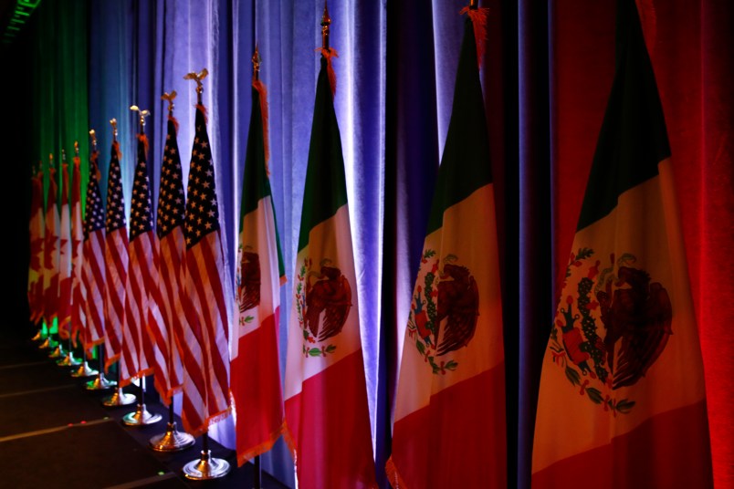 The flags of Canada, the U.S. and Mexico are lit by stage lights before a news conference, Wednesday, Aug. 16, 2017, at the start of NAFTA renegotiations in Washington. (AP Photo/Jacquelyn Martin)