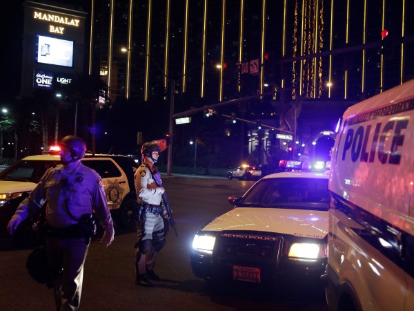 Police officers stand along the Las Vegas Strip the Mandalay Bay resort and casino during a shooting near the casino, Sunday, Oct. 1, 2017, in Las Vegas. (AP Photo/John Locher)