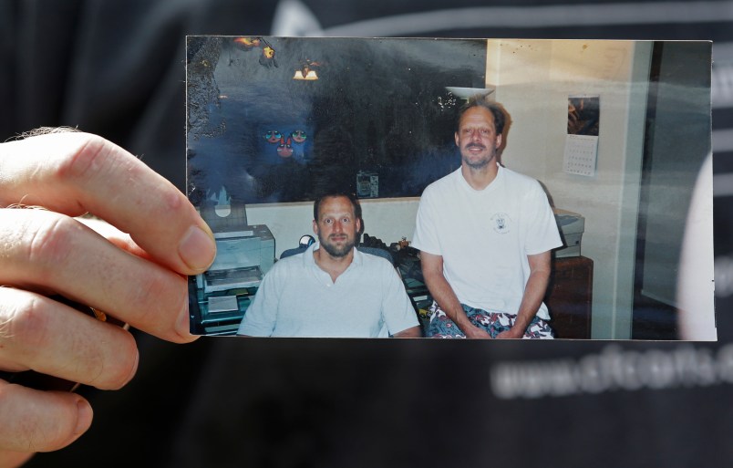 Eric Paddock, brother of  Las Vegas gunman Stephen Craig Paddock, holds up a photo of he and his brother outside his home, Monday, Oct. 2, 2017, in Orlando, Fla. Eric Paddock is on the left. (AP Photo/John Raoux)