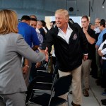 President Donald Trump shakes hands with San Juan Mayor Carmen Yulin Cruz during a briefing on hurricane recovery efforts with first responders at Luis Muniz Air National Guard Base, Tuesday, Oct. 3, 2017, in San Juan, Puerto Rico. (AP Photo/Evan Vucci)