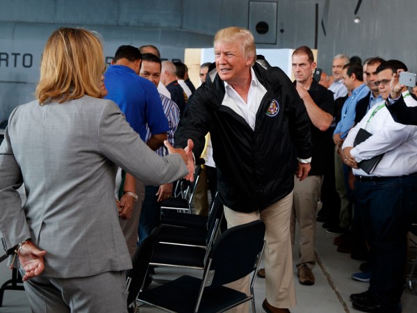 President Donald Trump shakes hands with San Juan Mayor Carmen Yulin Cruz during a briefing on hurricane recovery efforts with first responders at Luis Muniz Air National Guard Base, Tuesday, Oct. 3, 2017, in San Juan, Puerto Rico. (AP Photo/Evan Vucci)
