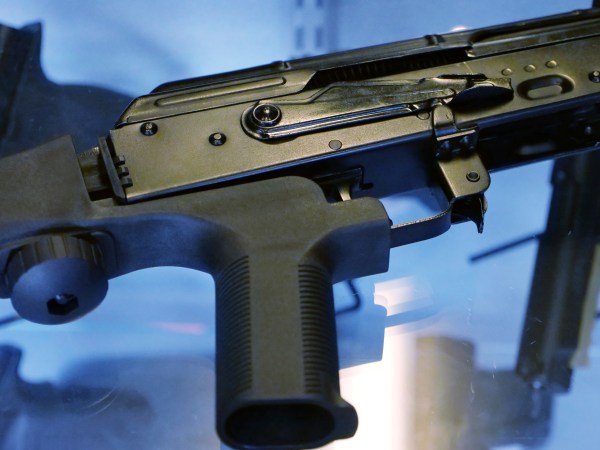 A little-known device called a "bump stock" is attached to a semi-automatic rifle at the Gun Vault store and shooting range Wednesday, Oct. 4, 2017, in South Jordan, Utah. (AP Photo/Rick Bowmer)