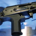 A little-known device called a "bump stock" is attached to a semi-automatic rifle at the Gun Vault store and shooting range Wednesday, Oct. 4, 2017, in South Jordan, Utah. (AP Photo/Rick Bowmer)