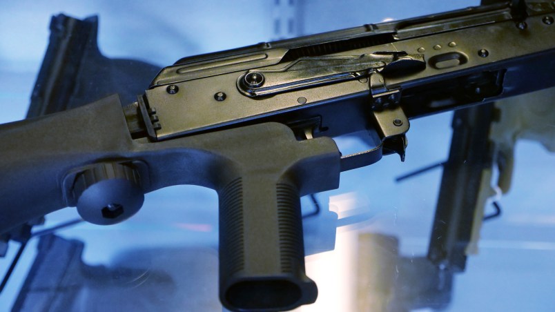 A little-known device called a "bump stock" is attached to a semi-automatic rifle at the Gun Vault store and shooting range Wednesday, Oct. 4, 2017, in South Jordan, Utah. (AP Photo/Rick Bowmer)
