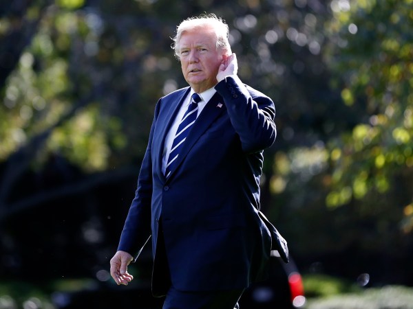 President Donald Trump holds his hand to his ear to hear a reporter's question as he walks to Marine One on the South Lawn of the White House to depart en route to South Carolina, Monday, Oct. 16, 2017, in Washington. (AP Photo/Alex Brandon)