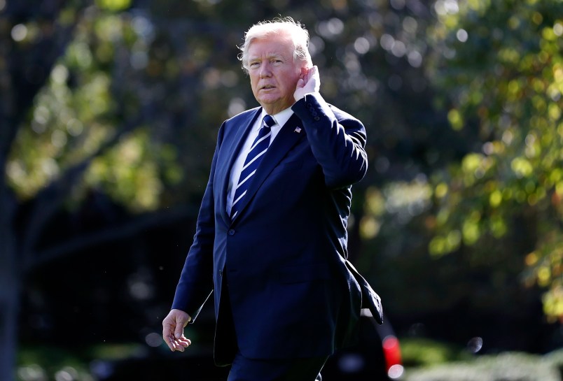 President Donald Trump holds his hand to his ear to hear a reporter's question as he walks to Marine One on the South Lawn of the White House to depart en route to South Carolina, Monday, Oct. 16, 2017, in Washington. (AP Photo/Alex Brandon)