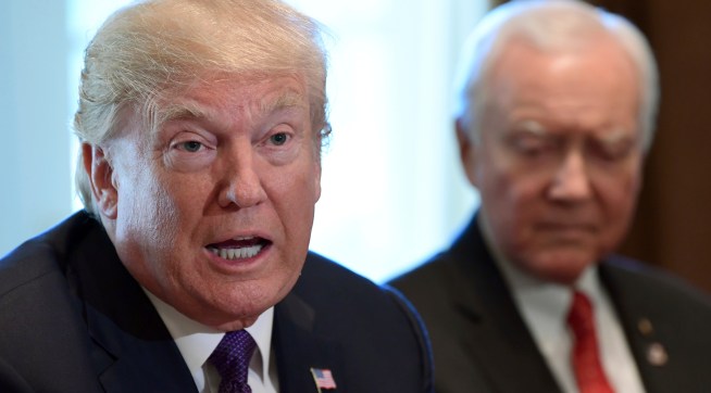 President Donald Trump, left, sitting next to Senate Finance Committee Chairman Sen. Orrin Hatch, R-Utah, right, speaks during a meeting of the committee and members of the President's economic team in the Cabinet Room of the White House in Washington, Wednesday, Oct. 18, 2017. (AP Photo/Susan Walsh)