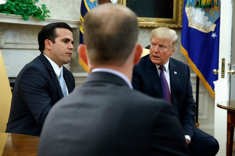 President Donald Trump listens as Governor Ricardo Rossello of Puerto Rico speaks during a meeting in the Oval Office of the White House, Thursday, Oct. 19, 2017, in Washington. (AP Photo/Evan Vucci)