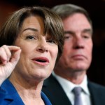 Sen. Amy Klobuchar, D-Minn., left, and Sen. Mark Warner, D-Va., speak about online political ads and preventing foreign interference in U.S. elections, during a news conference, Thursday, Oct. 19, 2017, on Capitol Hill in Washington. (AP Photo/Jacquelyn Martin)