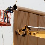 Crews work on a border wall prototype near the border with Tijuana, Mexico, Thursday, Oct. 19, 2017, in San Diego. Companies are nearing an Oct. 26 deadline to finish building eight prototypes of President Donald Trump’s proposed border wall with Mexico. The models, which cost the government up to about $500,000 each, should be able to take an hour of punishment from a sledgehammer, pickaxe, torch, chisel and battery-operated tools and be “aesthetically pleasing” from the U.S. side. (AP Photo/Gregory Bull)