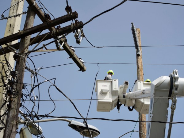 In this Thursday, Oct. 19, 2017 photo, a brigade from the Electric Power Authority repairs distribution lines damaged by the passage of Hurricane Maria in the Cantera community of San Juan, Puerto Rico. The storm struck after the Puerto Rico Electric Power Authority had filed for bankruptcy in July, put off badly needed maintenance and had just finished dealing with outages from Hurricane Irma. (AP Photo/Carlos Giusti)