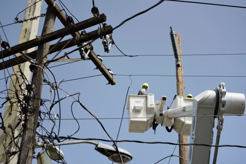 In this Thursday, Oct. 19, 2017 photo, a brigade from the Electric Power Authority repairs distribution lines damaged by the passage of Hurricane Maria in the Cantera community of San Juan, Puerto Rico. The storm struck after the Puerto Rico Electric Power Authority had filed for bankruptcy in July, put off badly needed maintenance and had just finished dealing with outages from Hurricane Irma. (AP Photo/Carlos Giusti)