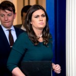 White House press secretary Sarah Huckabee Sanders, right, accompanied by deputy press secretary Hogan Gidley, left, arrives for the daily briefing in the Brady Press Briefing Room of the White House, Friday, Oct. 20, 2017, in Washington. (AP Photo/Andrew Harnik)