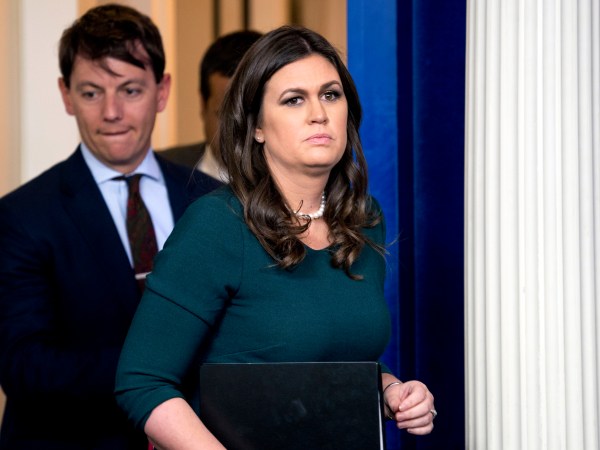 White House press secretary Sarah Huckabee Sanders, right, accompanied by deputy press secretary Hogan Gidley, left, arrives for the daily briefing in the Brady Press Briefing Room of the White House, Friday, Oct. 20, 2017, in Washington. (AP Photo/Andrew Harnik)