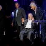 Former President George H.W. Bush, seated, waves as fellow former Presidents Bill Clinton, right, George W. Bush, and Jim Carter begin to walk off stage during a hurricanes relief concert in College Station, Texas, Saturday, Oct. 21, 2017. All five living former U.S. presidents joined to support a Texas concert raising money for relief efforts from Hurricane Harvey, Irma and Maria’s devastation in Texas, Florida, Puerto Rico and the U.S. Virgin Islands. (AP Photo/LM Otero)