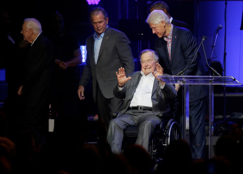 Former President George H.W. Bush, seated, waves as fellow former Presidents Bill Clinton, right, George W. Bush, and Jim Carter begin to walk off stage during a hurricanes relief concert in College Station, Texas, Saturday, Oct. 21, 2017. All five living former U.S. presidents joined to support a Texas concert raising money for relief efforts from Hurricane Harvey, Irma and Maria’s devastation in Texas, Florida, Puerto Rico and the U.S. Virgin Islands. (AP Photo/LM Otero)