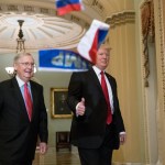 Small Russian flags are thrown by a protester as President Donald Trump, escorted by Senate Majority Leader Mitch McConnell, R-Ky., arrives on Capitol Hill to have lunch with Senate Republicans and push for his tax reform agenda, in Washington, Tuesday, Oct. 24, 2017. (AP Photo/J. Scott Applewhite)