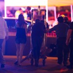 A wounded woman is moved outside the Tropicana during an active shooter situation on the Las Vegas Strip in Las Vegas Sunday, Oct. 1, 2017. Multiple victims were being transported to hospitals after a shooting late Sunday at a music festival on the Las Vegas Strip. (Chase Stevens/Las Vegas Review-Journal via AP)