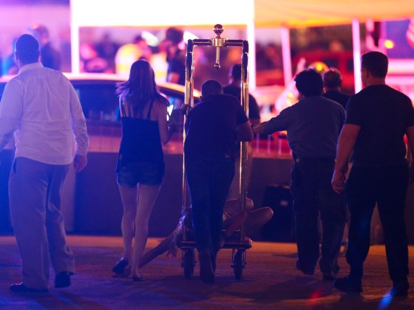 A wounded woman is moved outside the Tropicana during an active shooter situation on the Las Vegas Strip in Las Vegas Sunday, Oct. 1, 2017. Multiple victims were being transported to hospitals after a shooting late Sunday at a music festival on the Las Vegas Strip. (Chase Stevens/Las Vegas Review-Journal via AP)