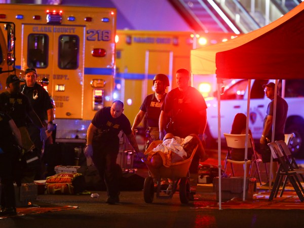 A wounded person is walked in on a wheelbarrow as Las Vegas police respond during an active shooter situation on the Las Vegas Stirp in Las Vegas  Sunday, Oct. 1, 2017. Multiple victims were being transported to hospitals after a shooting late Sunday at a music festival on the Las Vegas Strip. (Chase Stevens/Las Vegas Review-Journal via AP)