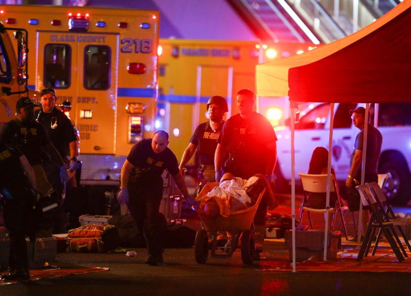 A wounded person is walked in on a wheelbarrow as Las Vegas police respond during an active shooter situation on the Las Vegas Stirp in Las Vegas  Sunday, Oct. 1, 2017. Multiple victims were being transported to hospitals after a shooting late Sunday at a music festival on the Las Vegas Strip. (Chase Stevens/Las Vegas Review-Journal via AP)