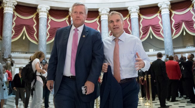 Rep. Mark Meadows, R-N.C., chairman of the conservative House Freedom Caucus, and Rep. Jim Jordan, R-Ohio, a key member of the group, walk through Statuary Hall at the Capitol in Washington, Wednesday, Sept. 13, 2017. With President Donald Trump wanting a legislative solution to replace the Deferred Action for Childhood Arrivals program, Meadows has said he will put together a working group to craft a conservative immigration plan. (AP Photo/J. Scott Applewhite)