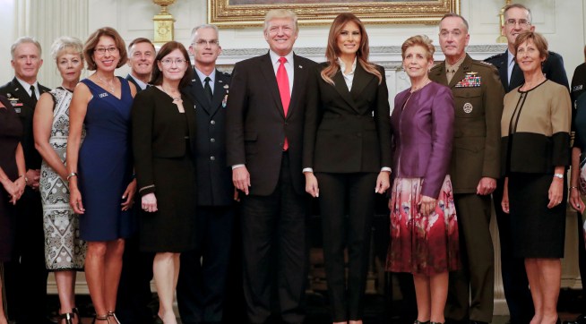 President Donald Trump and first lady Melania Trump, center, poses for a group photo with Senior Military leaders and spouses in the State Dining Room of the White House in Washington, Thursday, Oct. 5, 2017. Trump was hosting the dinner for the group this evening. (AP Photo/Pablo Martinez Monsivais)