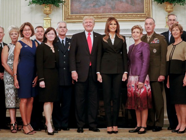 President Donald Trump and first lady Melania Trump, center, poses for a group photo with Senior Military leaders and spouses in the State Dining Room of the White House in Washington, Thursday, Oct. 5, 2017. Trump was hosting the dinner for the group this evening. (AP Photo/Pablo Martinez Monsivais)