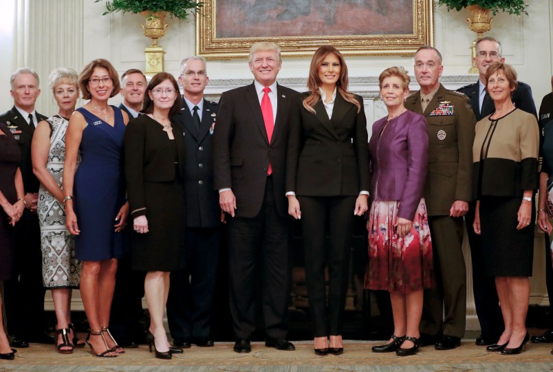 President Donald Trump and first lady Melania Trump, center, poses for a group photo with Senior Military leaders and spouses in the State Dining Room of the White House in Washington, Thursday, Oct. 5, 2017. Trump was hosting the dinner for the group this evening. (AP Photo/Pablo Martinez Monsivais)