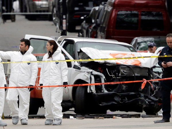 Law enforcement personnel examine the scene of a damaged Home Depot truck near the World Trade Center Memorial, Wednesday,  Nov. 1, 2017 in New York. (AP Photo/Mark Lennihan)